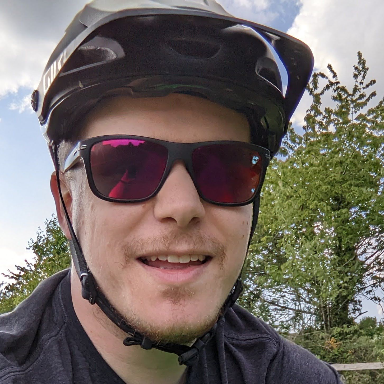 A picture of me, covered in mud standing next to my bike after a race